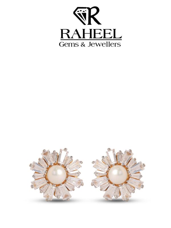 Close-up image of elegant pearl and Zircon stud earrings from Raheel Gems & Jewellers, featuring a central pearl surrounded by sparkling Zircon accents, set in a gold-tone metal. The earrings are displayed against a clean white background, highlighting their intricate design and shine.