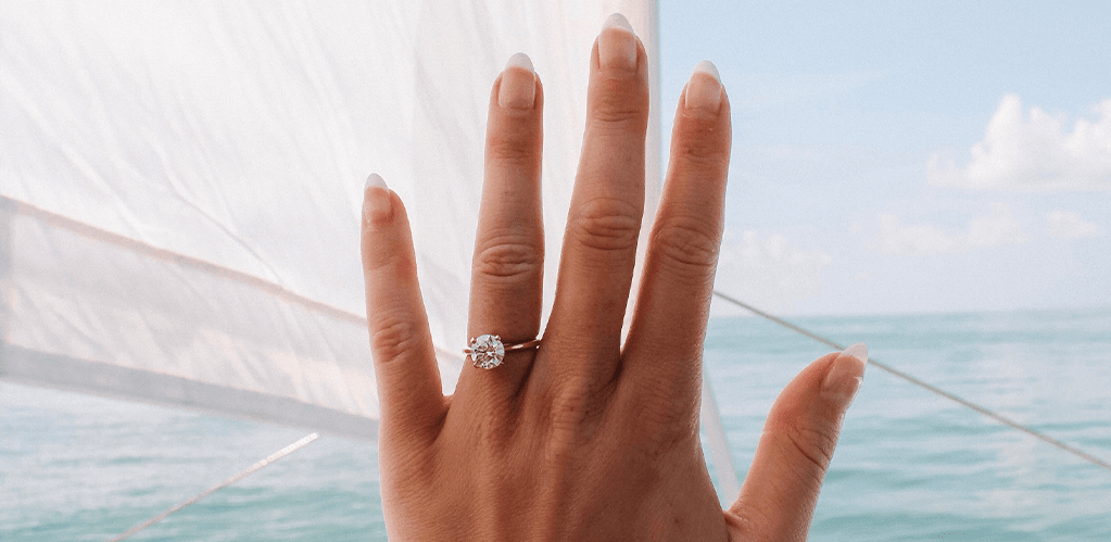 A visual showcasing a couple working together on designing their own ring, emphasizing the collaborative process and connection behind the custom jewelry creation.