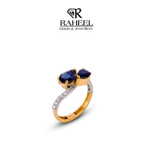 Sapphire and Zircon Toi et Moi Bypass Ring in 22kt gold featuring two pear-cut sapphires by Raheel Gems & Jewellers Karachi.